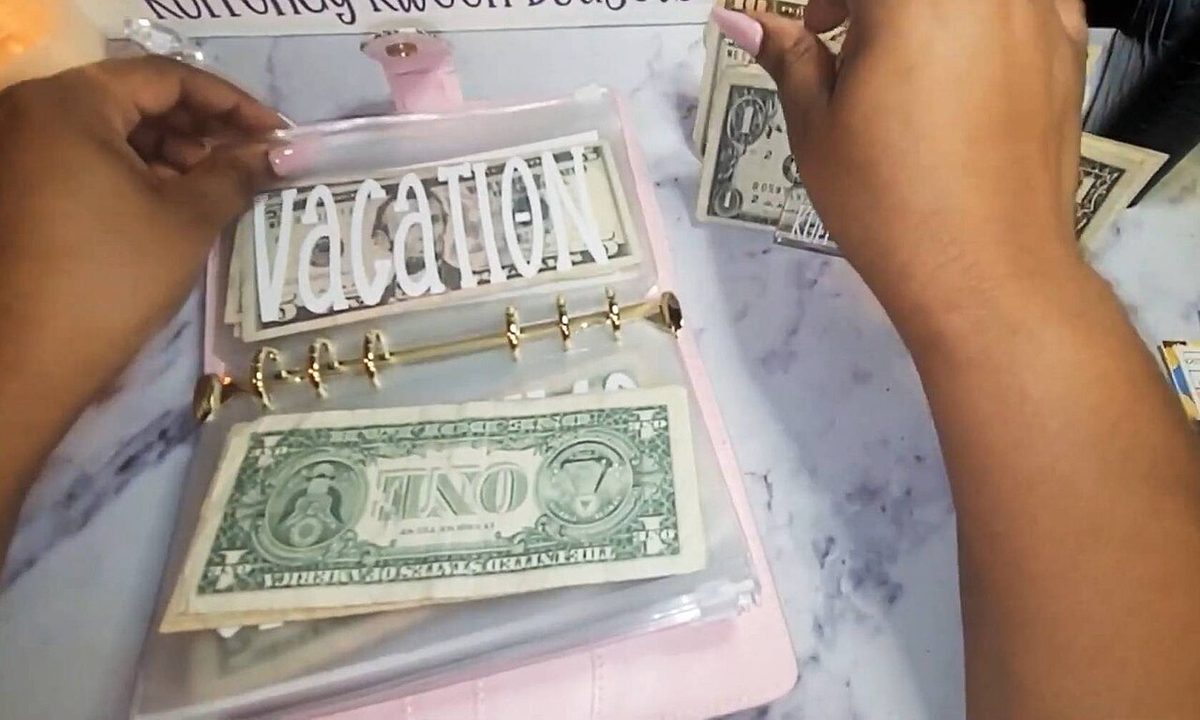 Cash divided into labelled envelopes for a monthly budget